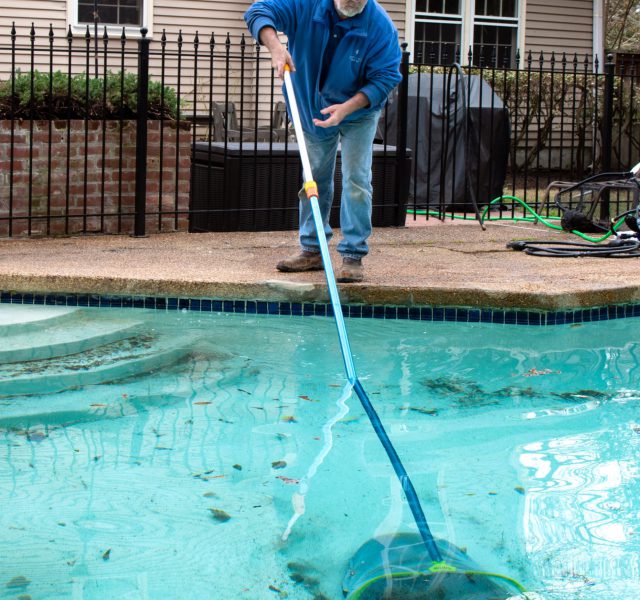 Removing foliage from the bottom of a swimming pool
