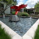 close up of pool with red sculpture