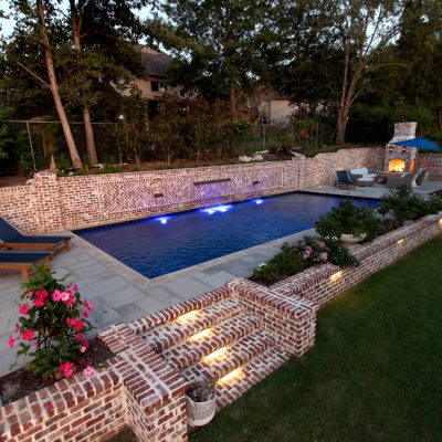 luxury pool with retaining wall and water features
