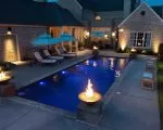 Thumnbail of luxury pool with fire features at night