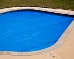 Thumnbail of Solar pool cover protecting a backyard swimming pool and retaining heat